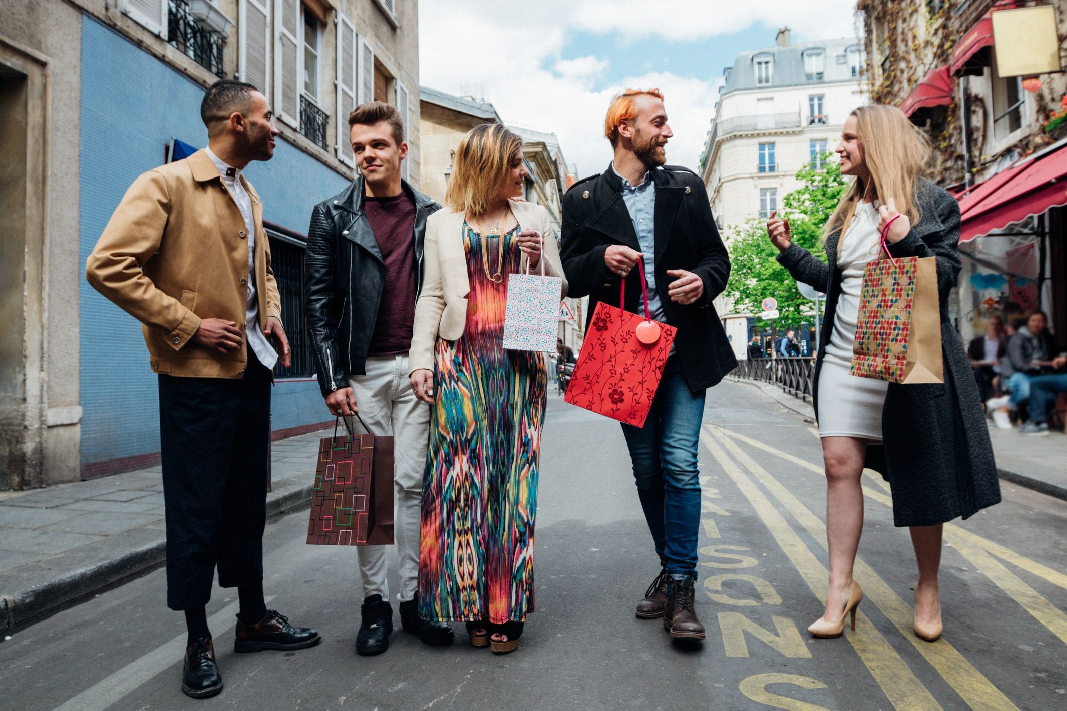 Friends walking through Paris with shopping bags