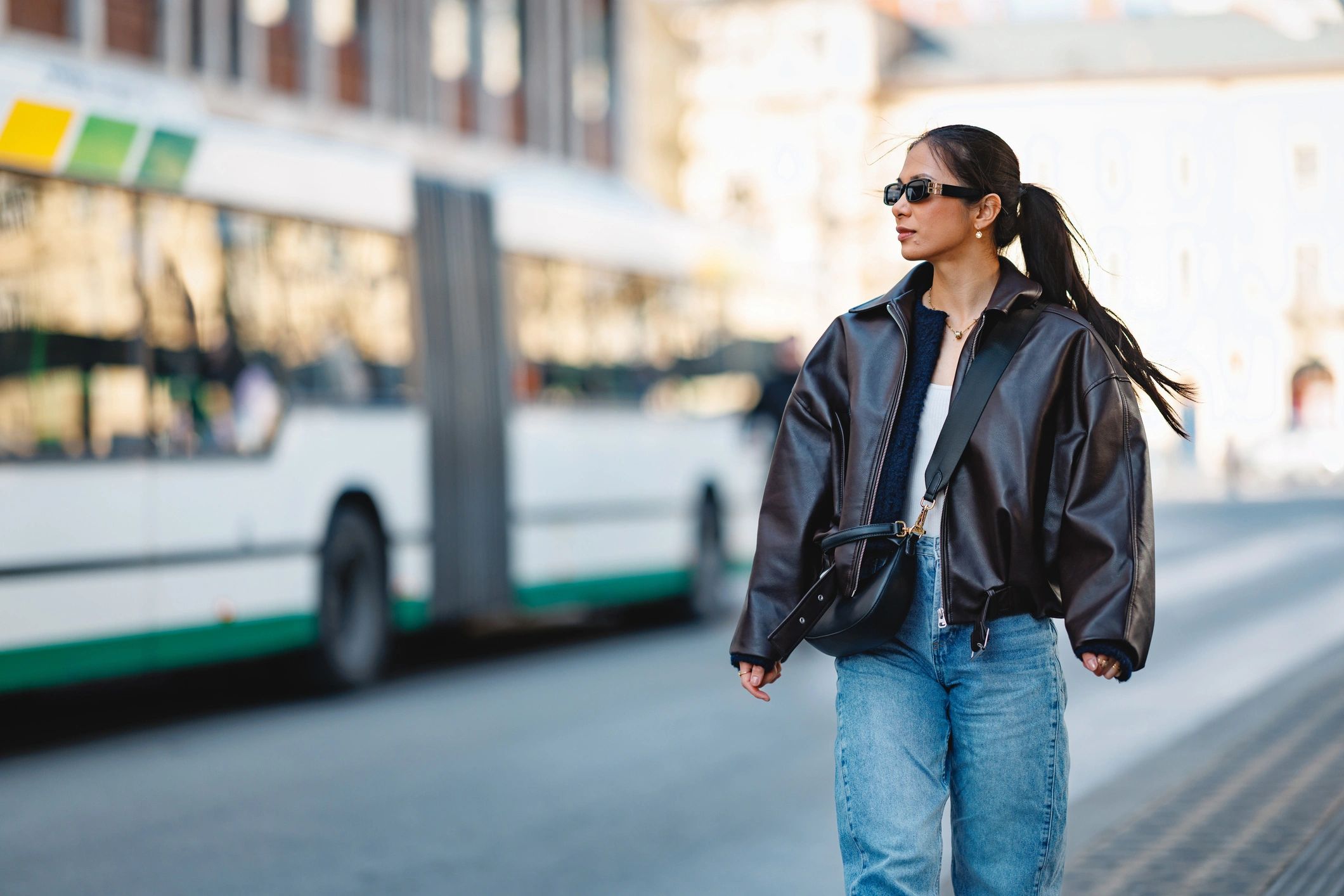 Woman in sunglasses and leather jacket on a Paris street